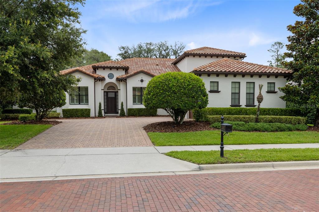 A single-story stucco house with a tile roof and a brick driveway — 2218 SOARING EAGLE PLACE, LAKE MARY, FL