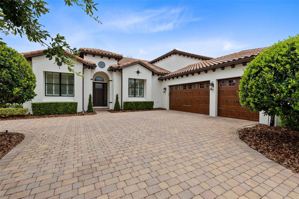 A single-story house with a white stucco exterior, tile roof, and a paved driveway — 2218 SOARING EAGLE PLACE, LAKE MARY, FL