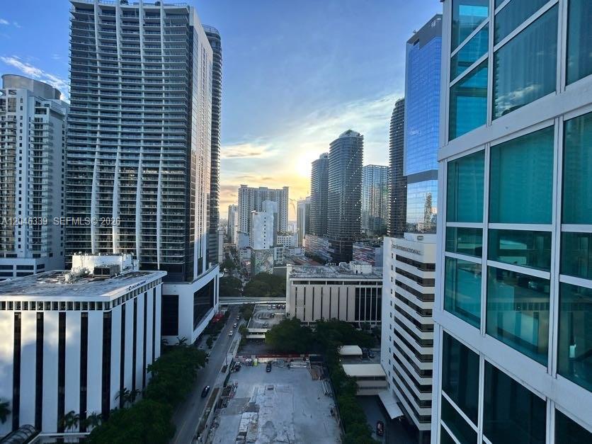An elevated view of a dense urban skyline featuring multiple high-rise buildings at sunset — 951 Brickell Ave # 2011, Miami FL 33131, MIAMI, FL