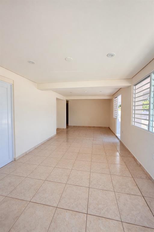 An empty, rectangular room with beige tile flooring, recessed ceiling lights, and louvered windows — Carr 901 BARRIO CAMINO NUEVO, YABUCOA, PR