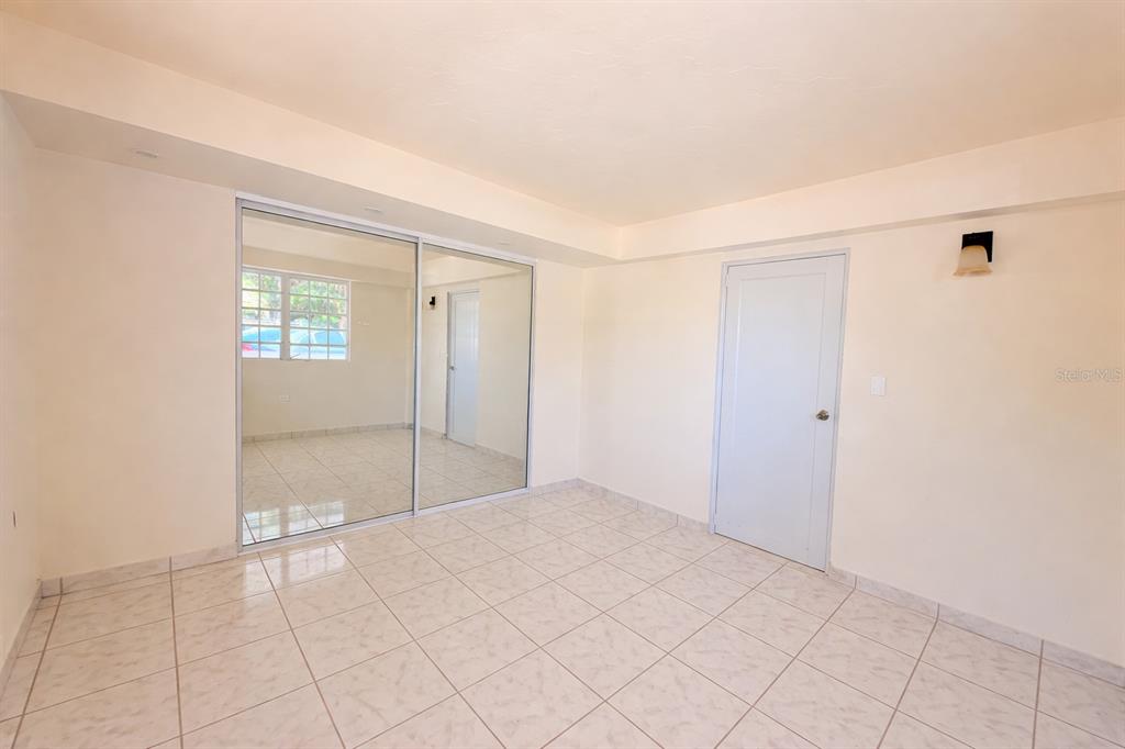 A room with white tiled floors, a mirrored closet, and a white door — Carr 901 BARRIO CAMINO NUEVO, YABUCOA, PR