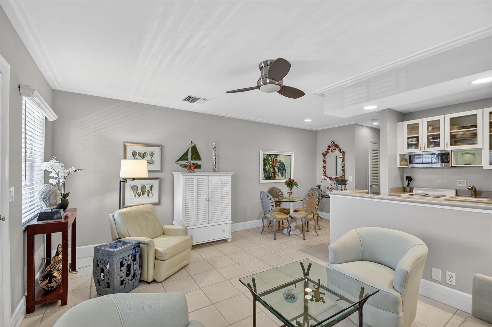 A living room and dining area with tile floors, a ceiling fan, and open kitchen — 5505 N Ocean Boulevard # 204, Ocean Ridge FL 33435, OCEAN RIDGE, FL