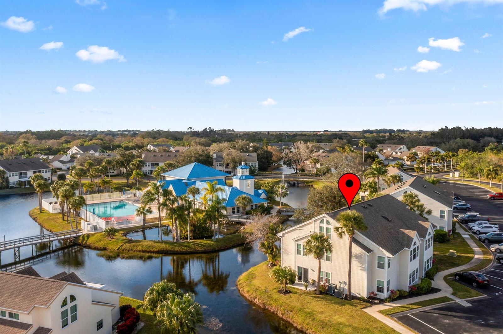 An aerial view shows a multi-story residential building with a red location pin on its roof — 1907 Aynsley Way # 321, Vero Beach FL 32966, VERO BEACH, FL