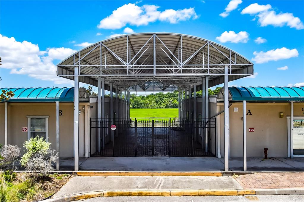 A single-story commercial building with a metal roof and a covered walkway exterior — 11734 JEFFERSON ROAD, THONOTOSASSA, FL