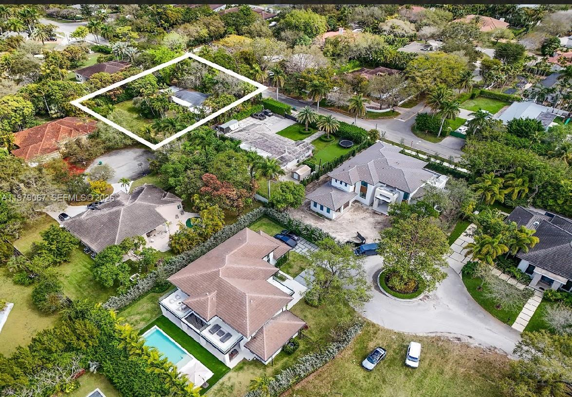 An aerial view shows a residential property outlined in white amidst a lush, tree-filled neighborhood — 9330 SW 72nd Ave, Pinecrest FL 33156, PINECREST, FL