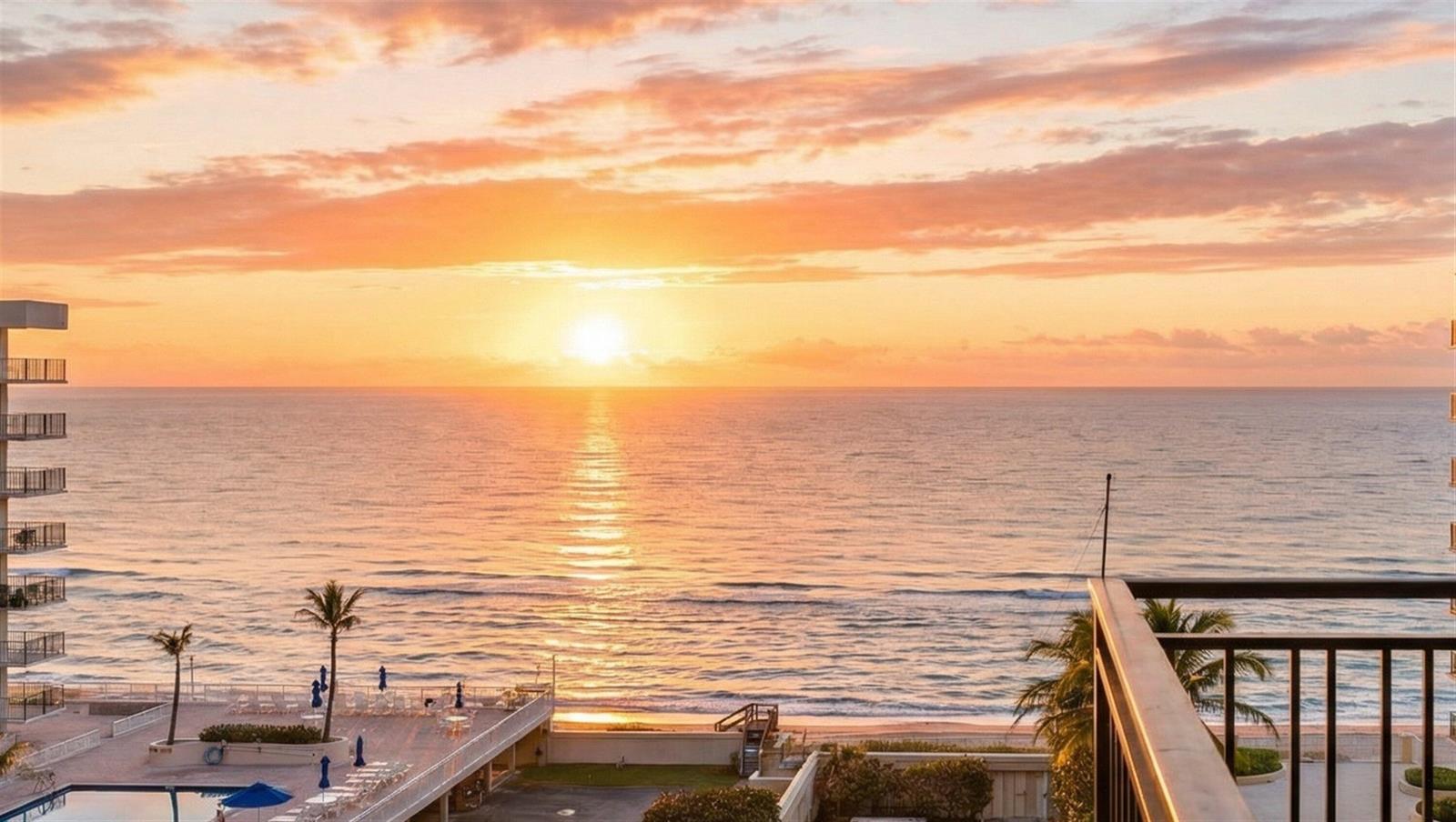 A balcony view overlooks a beach and ocean at sunset with a nearby resort pool — 3475 S Ocean Boulevard # 715, Palm Beach FL 33480, PALM BEACH, FL