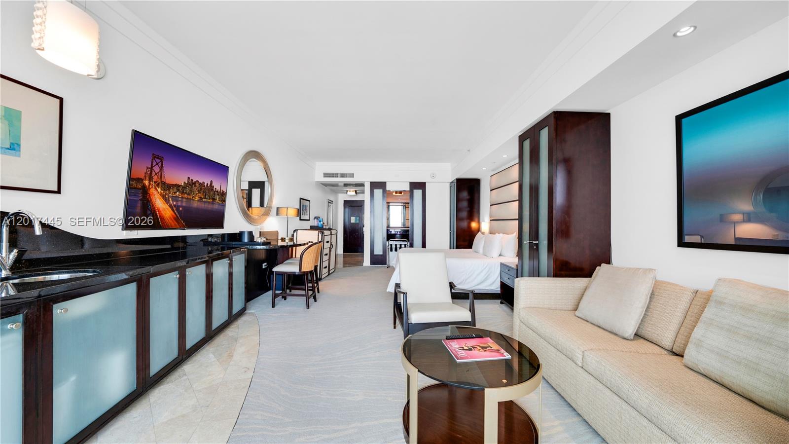 A hotel room features a kitchenette, a seating area with a sofa, and a bed — 4391 Collins Ave # 1903, Miami Beach FL 33140, MIAMI BEACH, FL