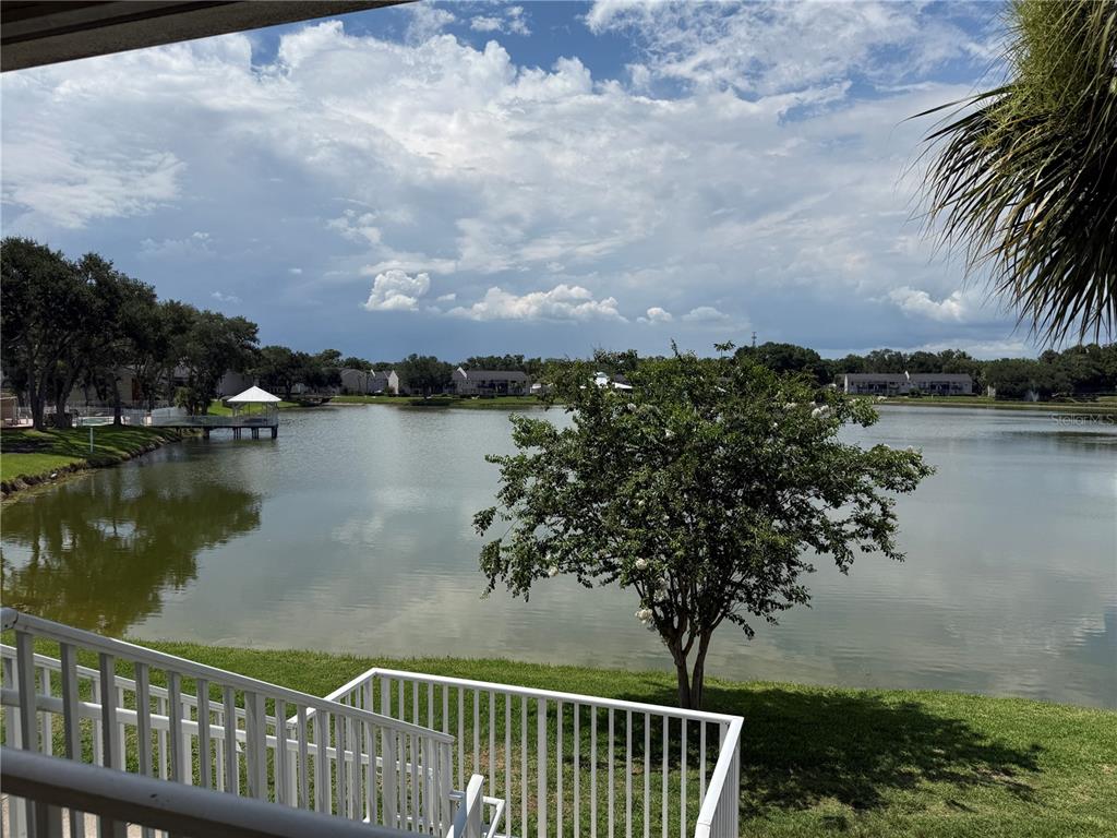 A view of a lake and residential buildings from a white-railed balcony — 220 LAKE PARSONS GREEN UNIT 205, BRANDON, FL