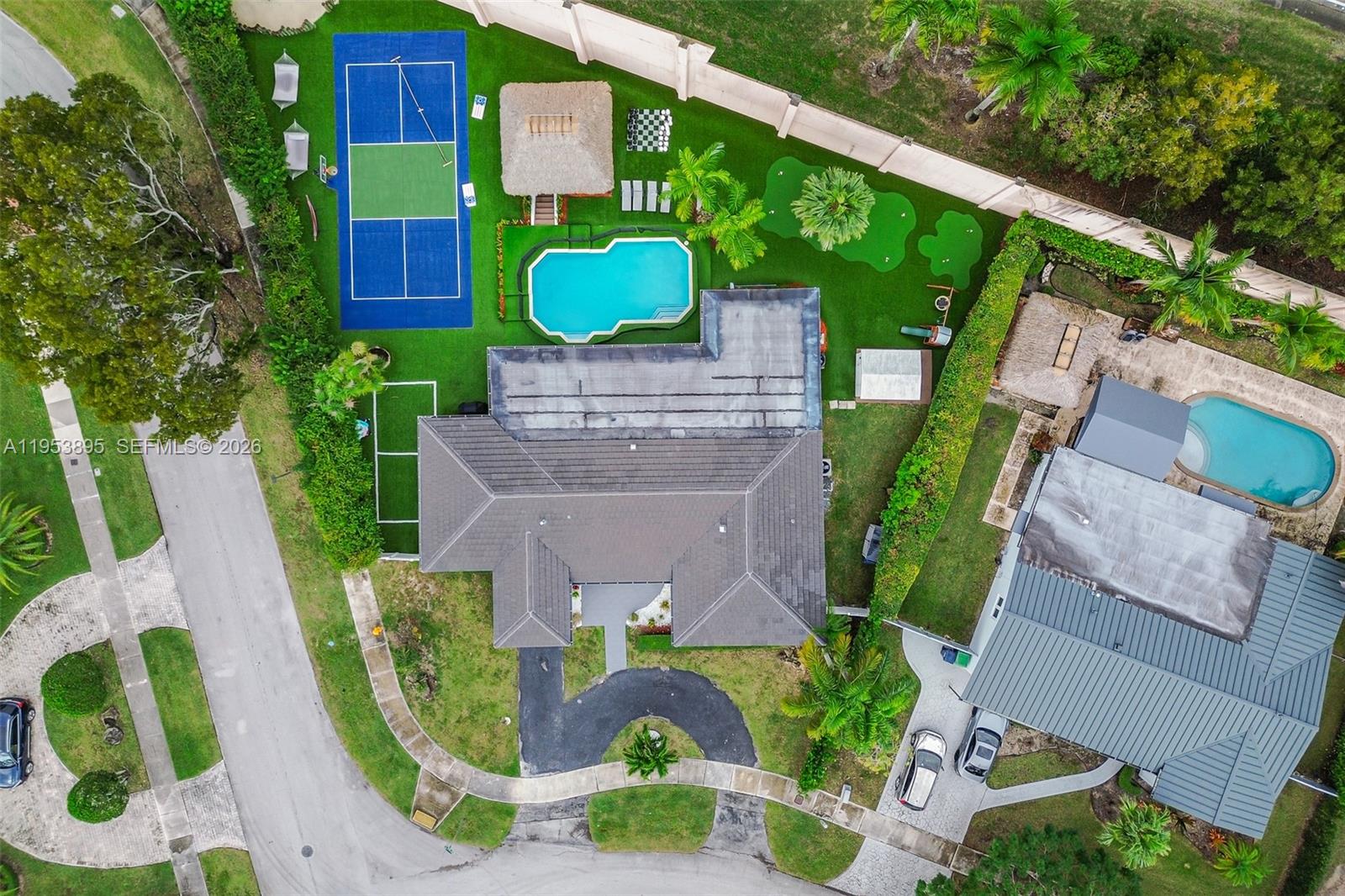 An aerial view shows a house with a pool, pickleball court, and putting green — 10870 SW 106th Ave, Miami FL 33176, MIAMI, FL