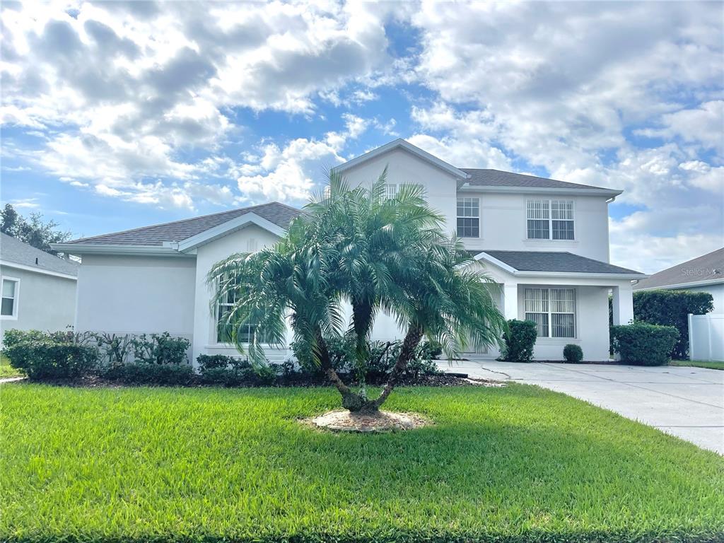 A two-story white house with a palm tree in the front yard — 2370 HINSDALE DRIVE, KISSIMMEE, FL