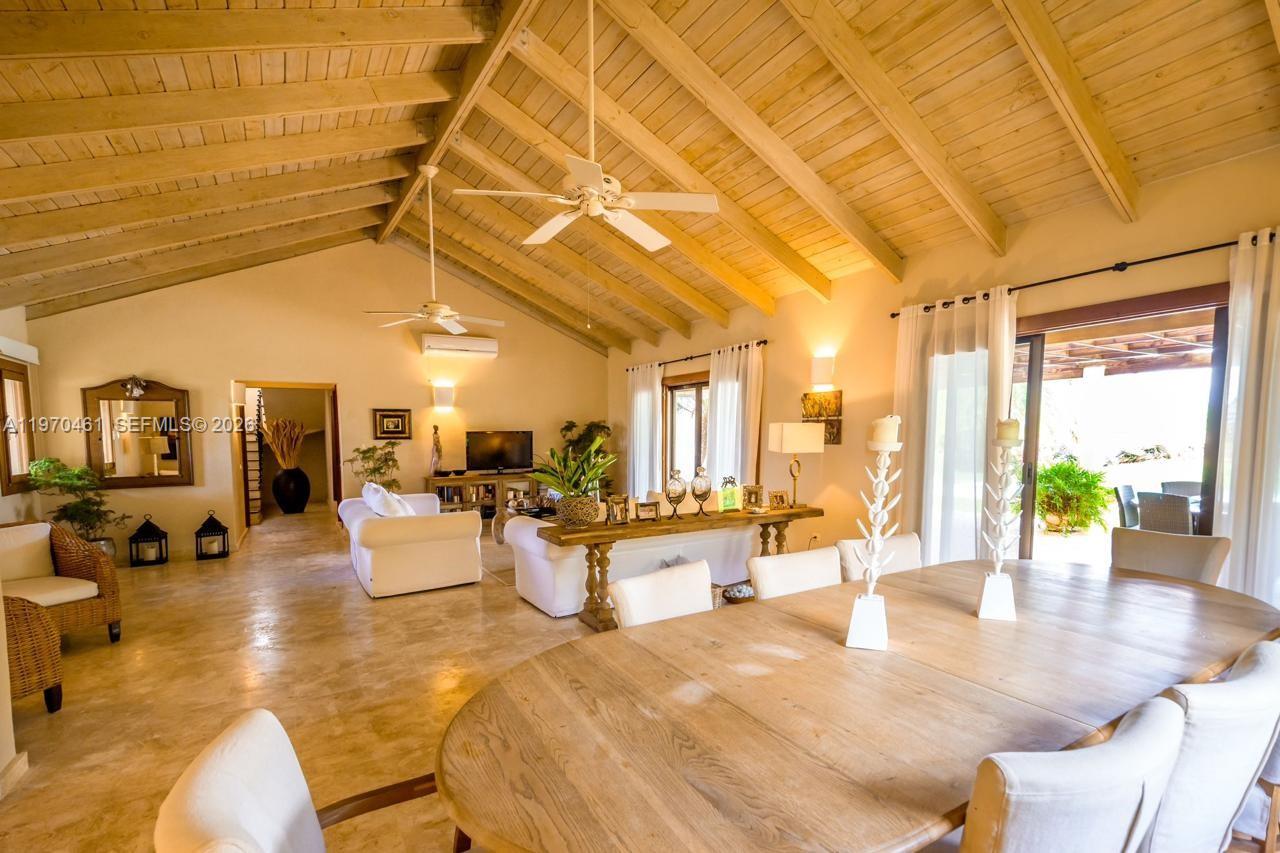 A spacious living and dining area features a vaulted wood-beam ceiling and tile flooring — Los Robles 8, La Estancia Golf Resort, DR, DR