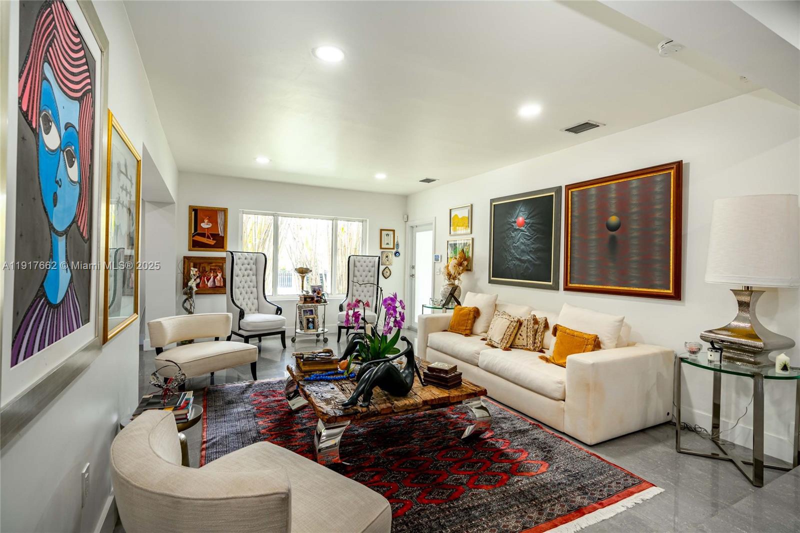 A white stucco wall with a black gate encloses a house with a tiled roof — 1360 SW 16th St, Miami FL 33145, MIAMI, FL