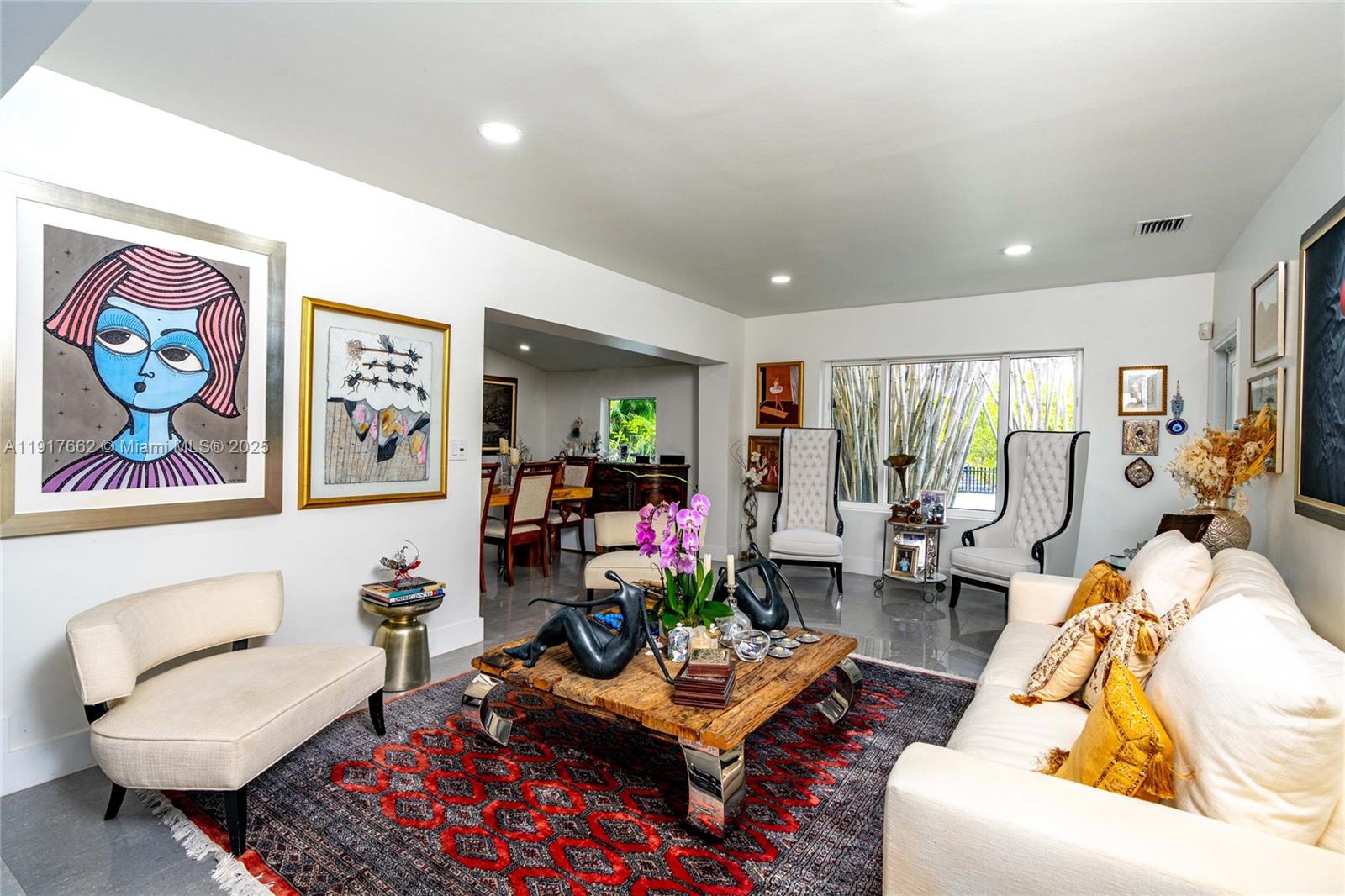 A patio features a round stone table with four chairs and a potted orchid centerpiece — 1360 SW 16th St, Miami FL 33145, MIAMI, FL