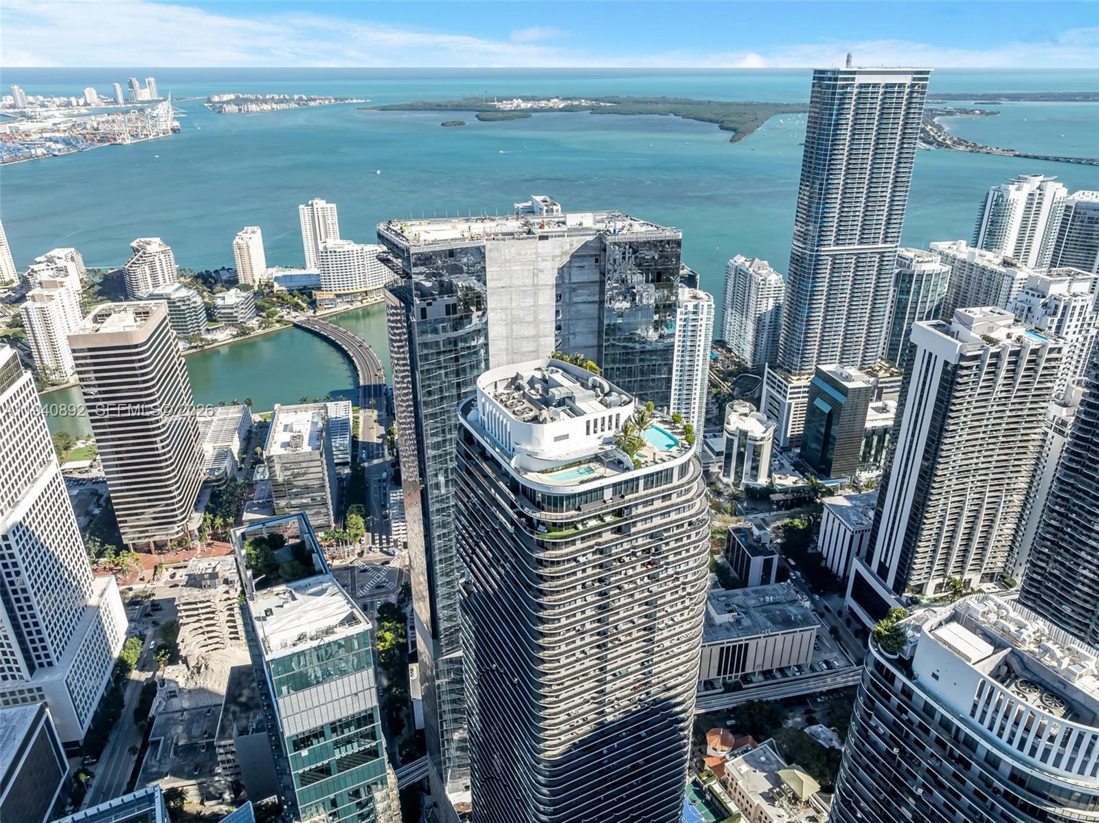 An aerial view of high-rise buildings in a coastal city with a bay in the background — 801 S Miami Ave # 2905, Miami FL 33130, MIAMI, FL