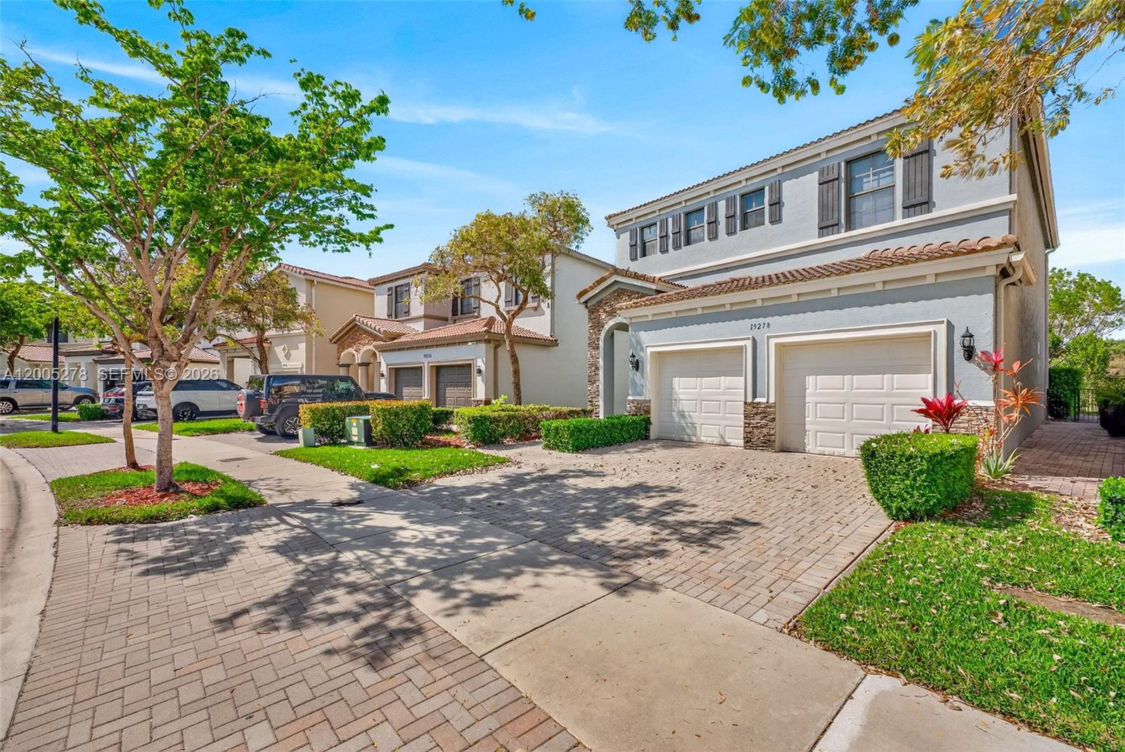 A two-story suburban house with a two-car garage and a brick-paved driveway — 19278 NE 6th Ave, Miami FL 33179, MIAMI, FL