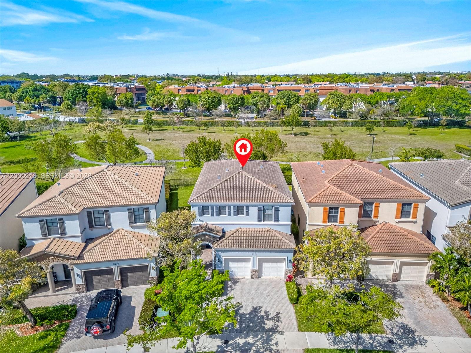An aerial view shows a two-story house with a tiled roof and a two-car garage — 19278 NE 6th Ave, Miami FL 33179, MIAMI, FL