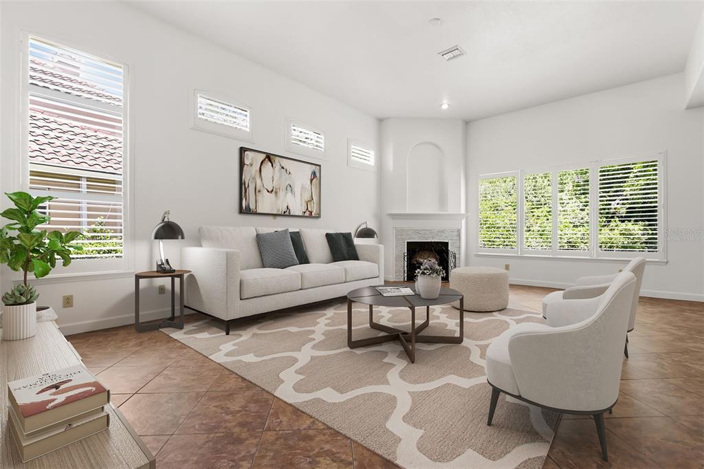 A living room features a white sofa, two armchairs, a coffee table, and a fireplace — 2724 NORTHAMPTON AVENUE, ORLANDO, FL