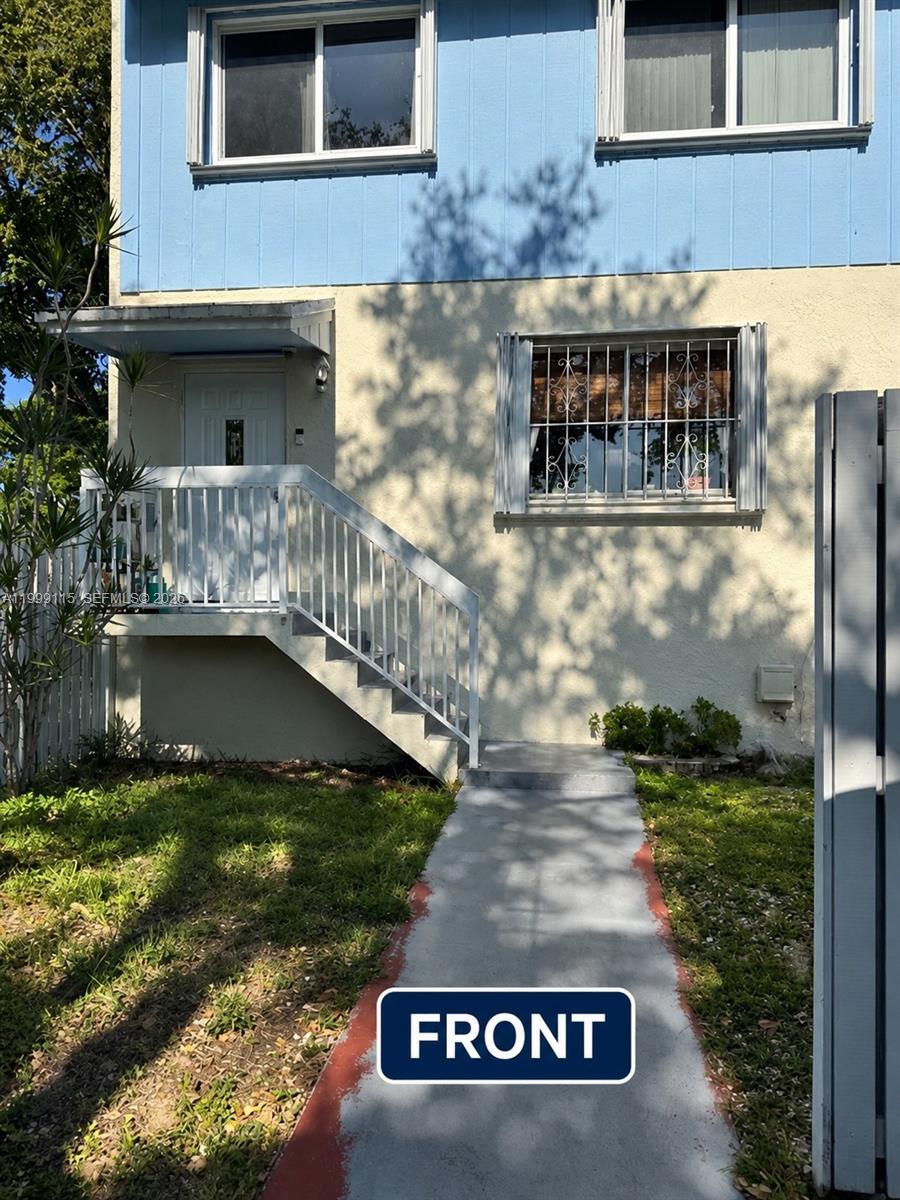The exterior of a two-story building features a white staircase leading to the front door — 22105 SW 103rd Ct, Cutler Bay FL 33190, CUTLER BAY, FL