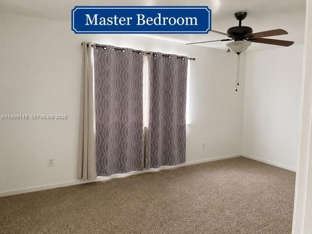 A master bedroom features beige carpeting, white walls, patterned curtains, and a ceiling fan — 22105 SW 103rd Ct, Cutler Bay FL 33190, CUTLER BAY, FL
