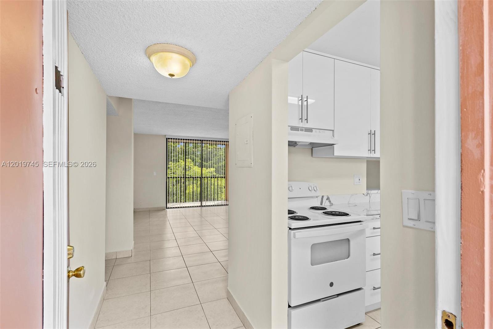 A kitchen features white cabinets, marble-patterned countertops, a stainless steel sink, and white appliances — 8600 SW 133rd Ave Rd # 410, Miami FL 33183, MIAMI, FL