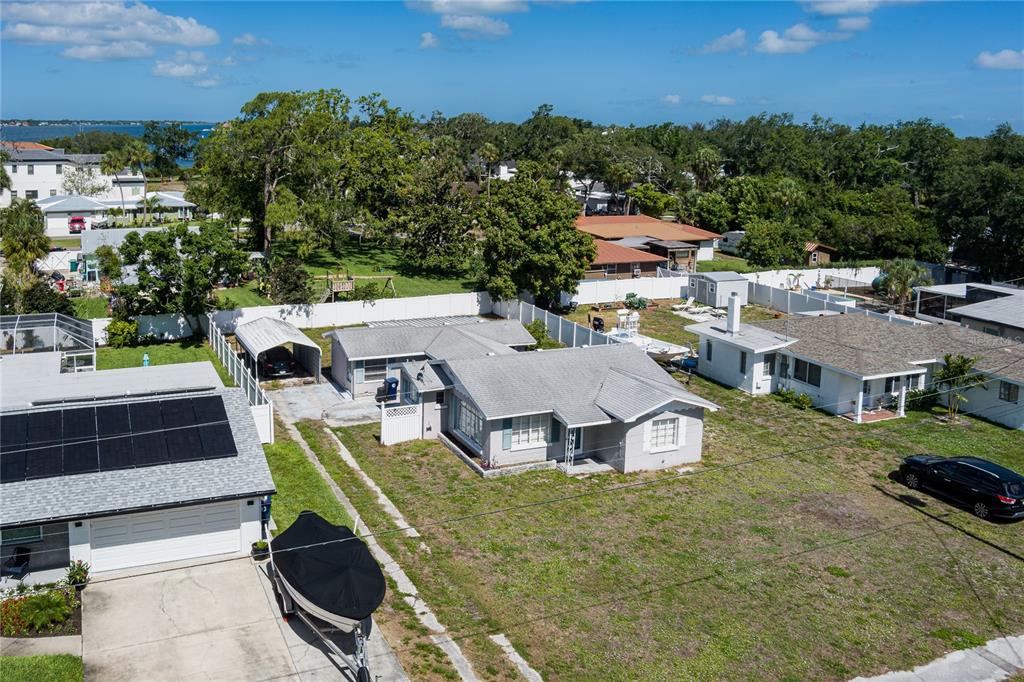 An aerial view of a gray single-story house with a boat parked in the driveway — 415 20TH AVENUE W, PALMETTO, FL