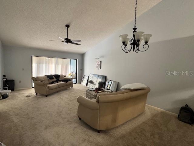 A living room features two beige sofas, a ceiling fan, and a hanging chandelier — 5924 CLUBSIDE DRIVE, SARASOTA, FL