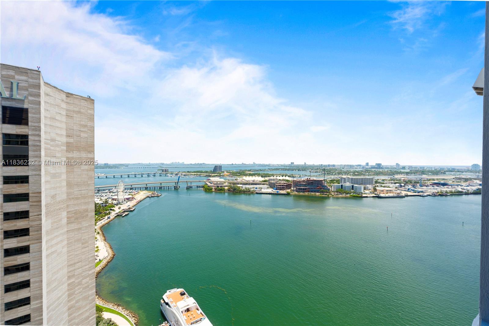 An elevated view of a bay with a bridge, a Ferris wheel, and a boat — 335 S Biscayne Blvd # 3410, Miami FL 33131, MIAMI, FL