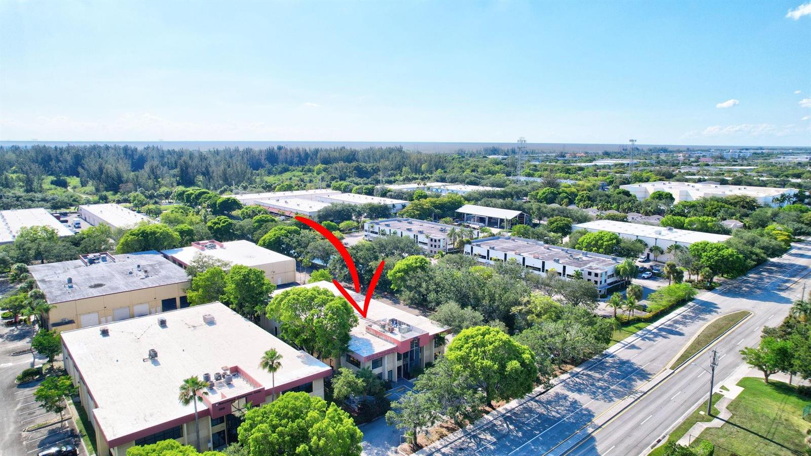 An aerial view shows a commercial building complex surrounded by trees and a nearby road — 4505 NW 103rd Avenue, Sunrise FL 33351, SUNRISE, FL