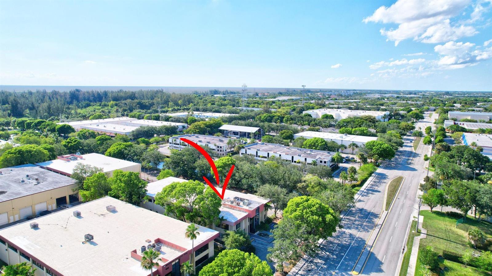 An aerial view shows a commercial building complex surrounded by trees and a nearby road — 4505 NW 103rd Avenue, Sunrise FL 33351, SUNRISE, FL