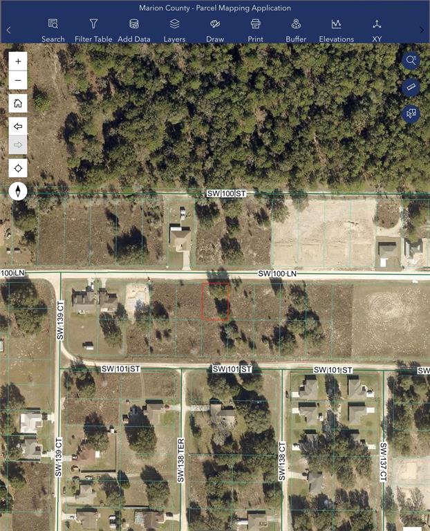 This is a satellite map showing a vacant residential lot outlined in red — SW 100TH LANE, DUNNELLON, FL