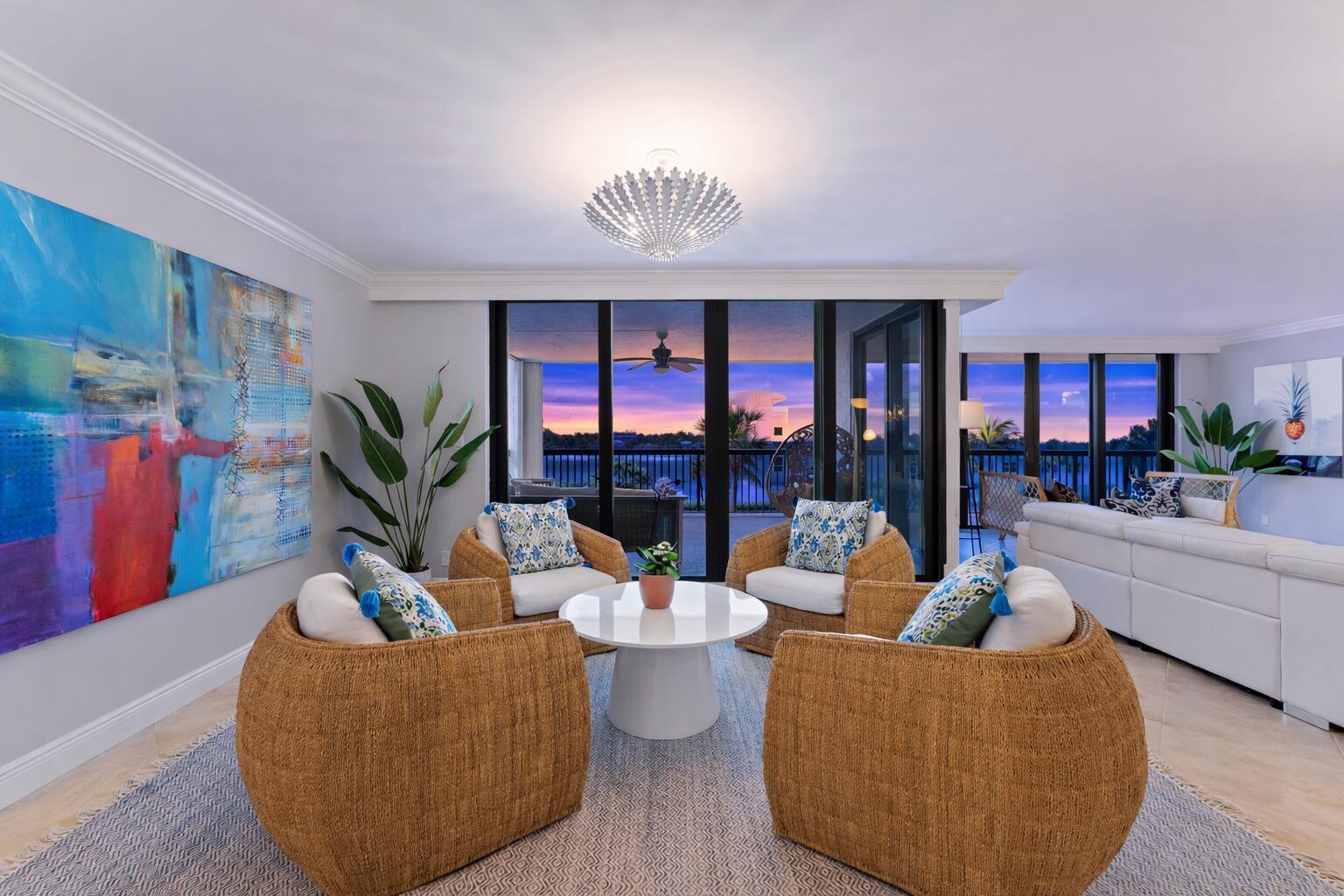 A living area features four wicker chairs, a white coffee table, and a sunset view — 19670 Beach Road # B303, Jupiter FL 33469, JUPITER, FL