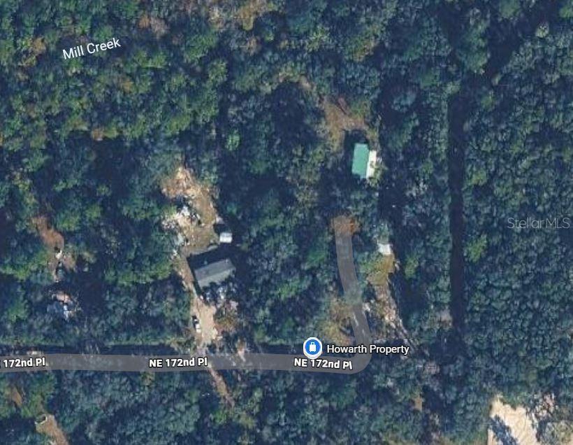 This aerial map view shows a wooded property with two buildings and a driveway — NE 172ND PL LOT 11, FORT MC COY, FL