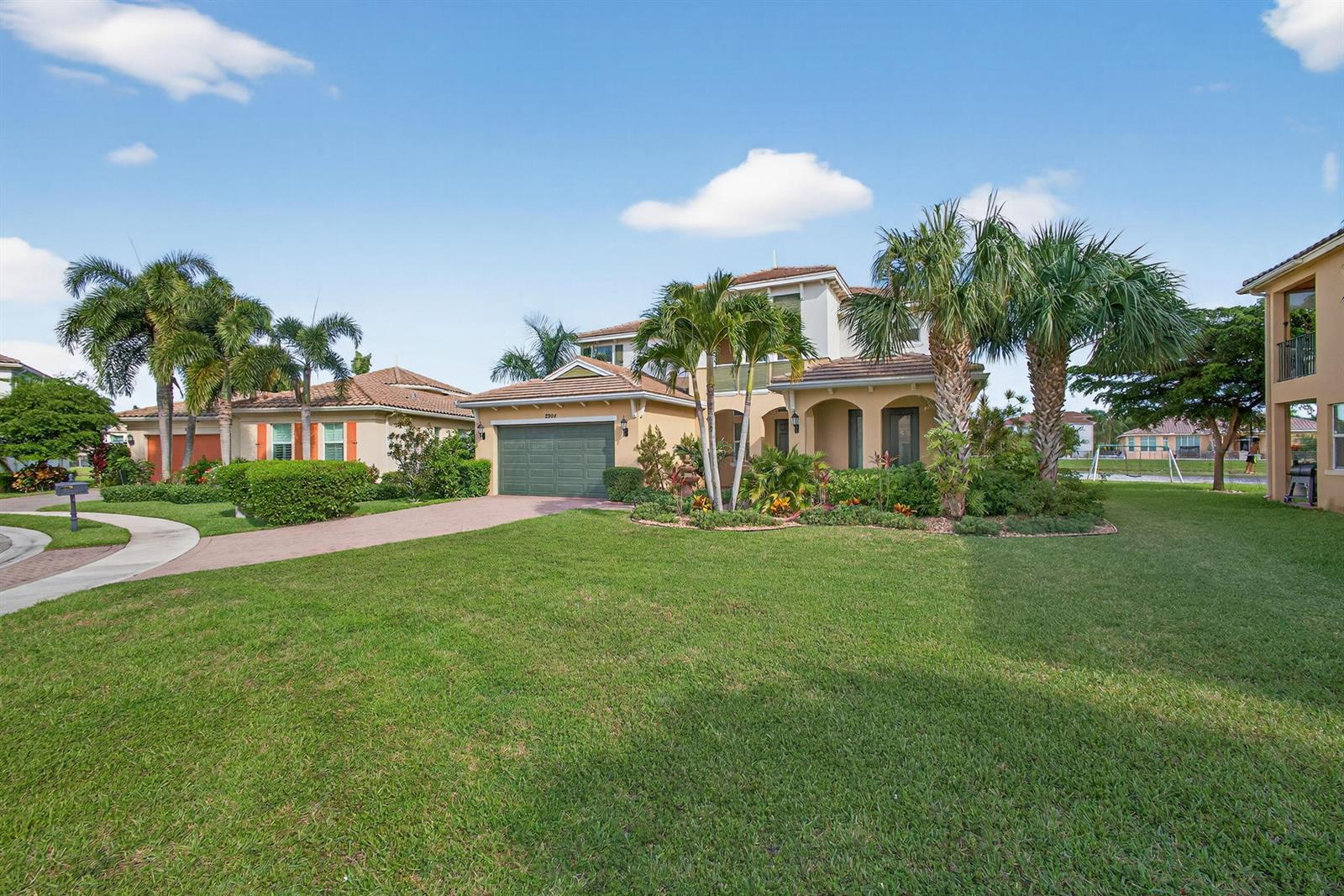 A two-story suburban house with a green garage and palm trees in the front yard — 2904 Payson Way, Wellington FL 33414, WELLINGTON, FL