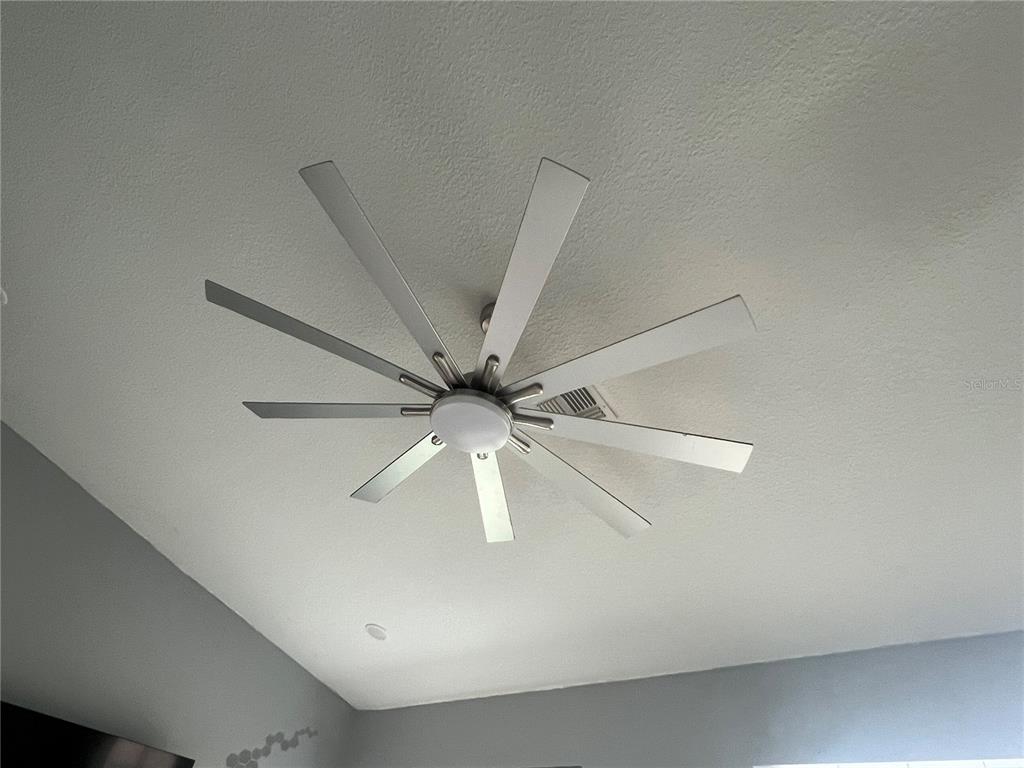 A modern ceiling fan with multiple silver blades and a central light fixture — 1730 EAST PARKWAY, DELAND, FL