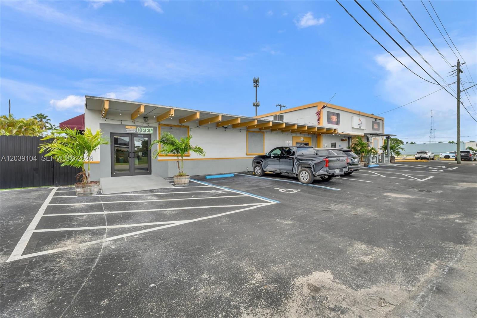 A low-rise commercial building with a parking lot and a covered entrance — HOMESTEAD, FL
