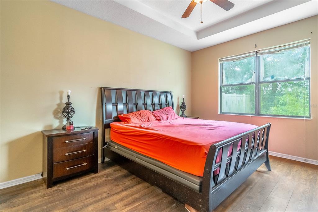 A bathroom features a double vanity, a tiled shower, and a built-in soaking tub — 9907 ARMANDO CIRCLE, ORLANDO, FL