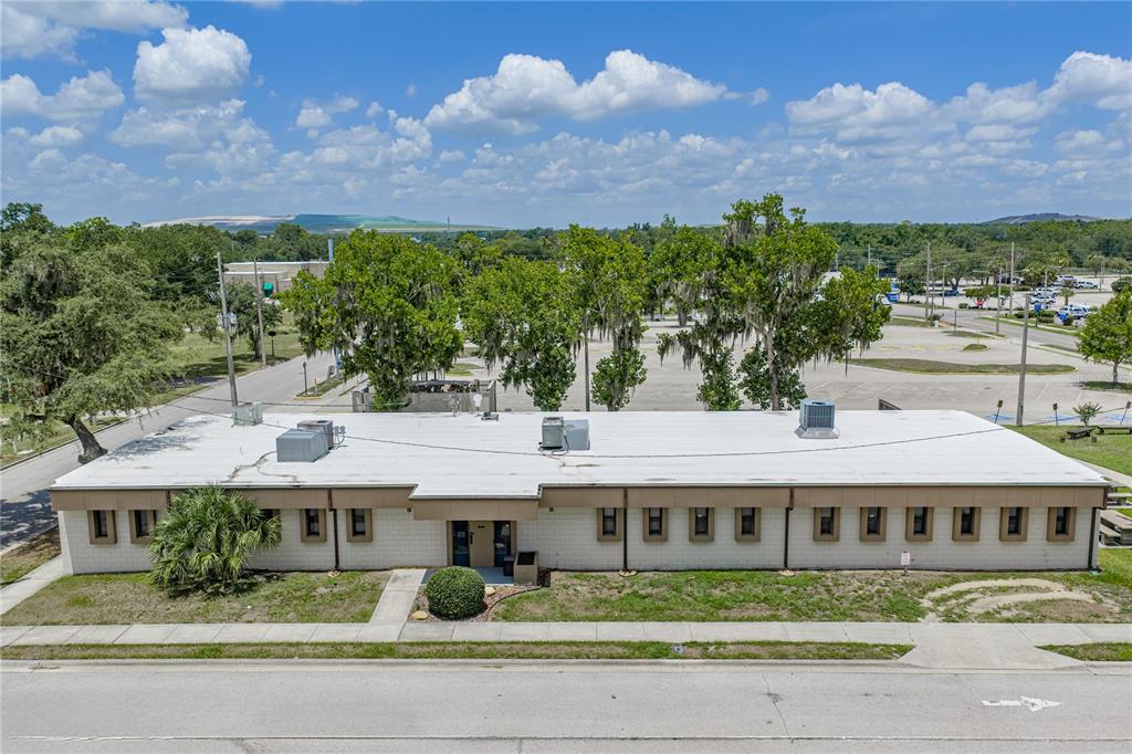 An aerial view shows a single-story commercial building with a flat roof and parking lot — 215 MARY RECKEWEG WAY, BARTOW, FL