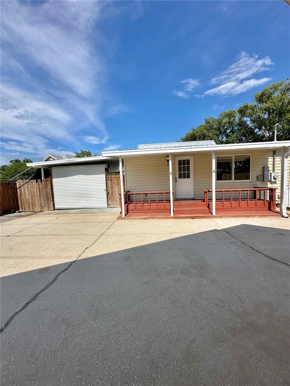 A single-story house with light siding, a front porch, and an attached garage — 606 NEW YORK AVE UNIT New York Ave, ST CLOUD, FL