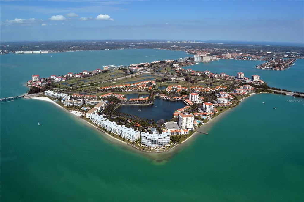 An aerial view of a residential island community surrounded by water with a central lake — 5200 BRITTANY DRIVE S UNIT 1804, ST PETERSBURG, FL