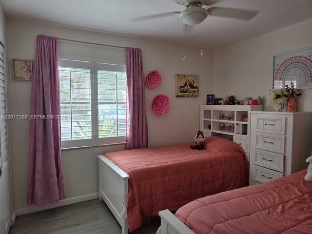 A bedroom features two twin beds with pink bedding, white furniture, and pink curtains — 19 Chestnut Cir, Cooper City FL 33026, COOPER CITY, FL