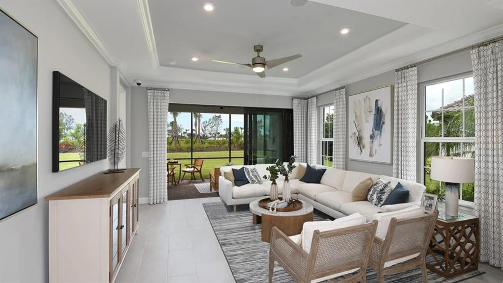 A living room features a sectional sofa, two armchairs, a ceiling fan, and sliding doors — 3209 TORTA COURT, BRADENTON, FL