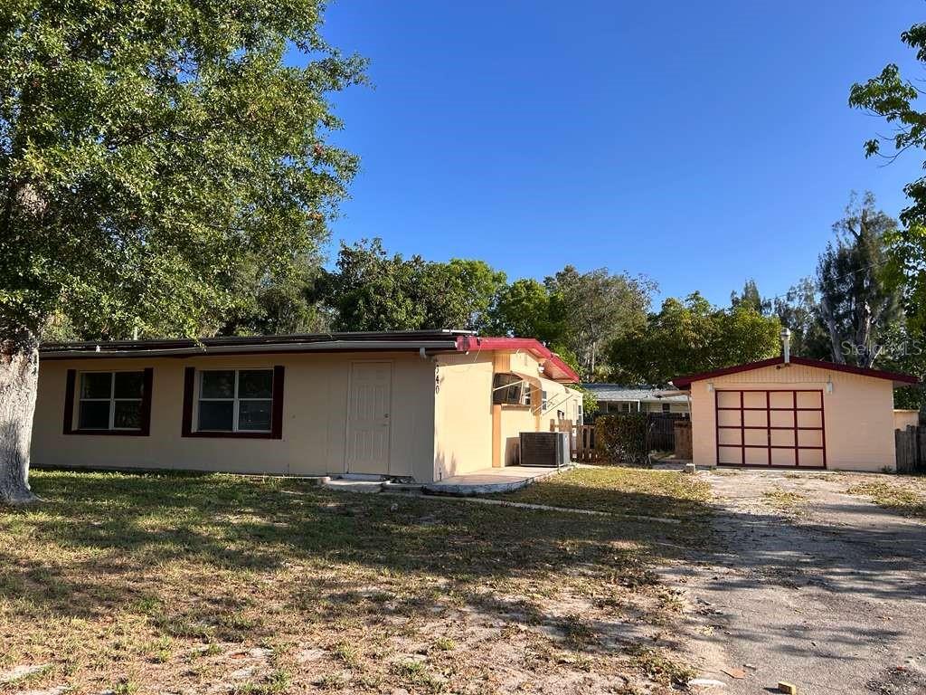 A single-story house with a detached garage and a large tree in the front yard — 340 SANTA BARBARA STREET, NORTH FORT MYERS, FL