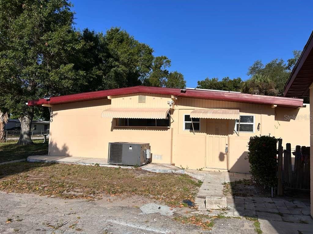 A single-story tan house with a red roof and window awnings — 340 SANTA BARBARA STREET, NORTH FORT MYERS, FL
