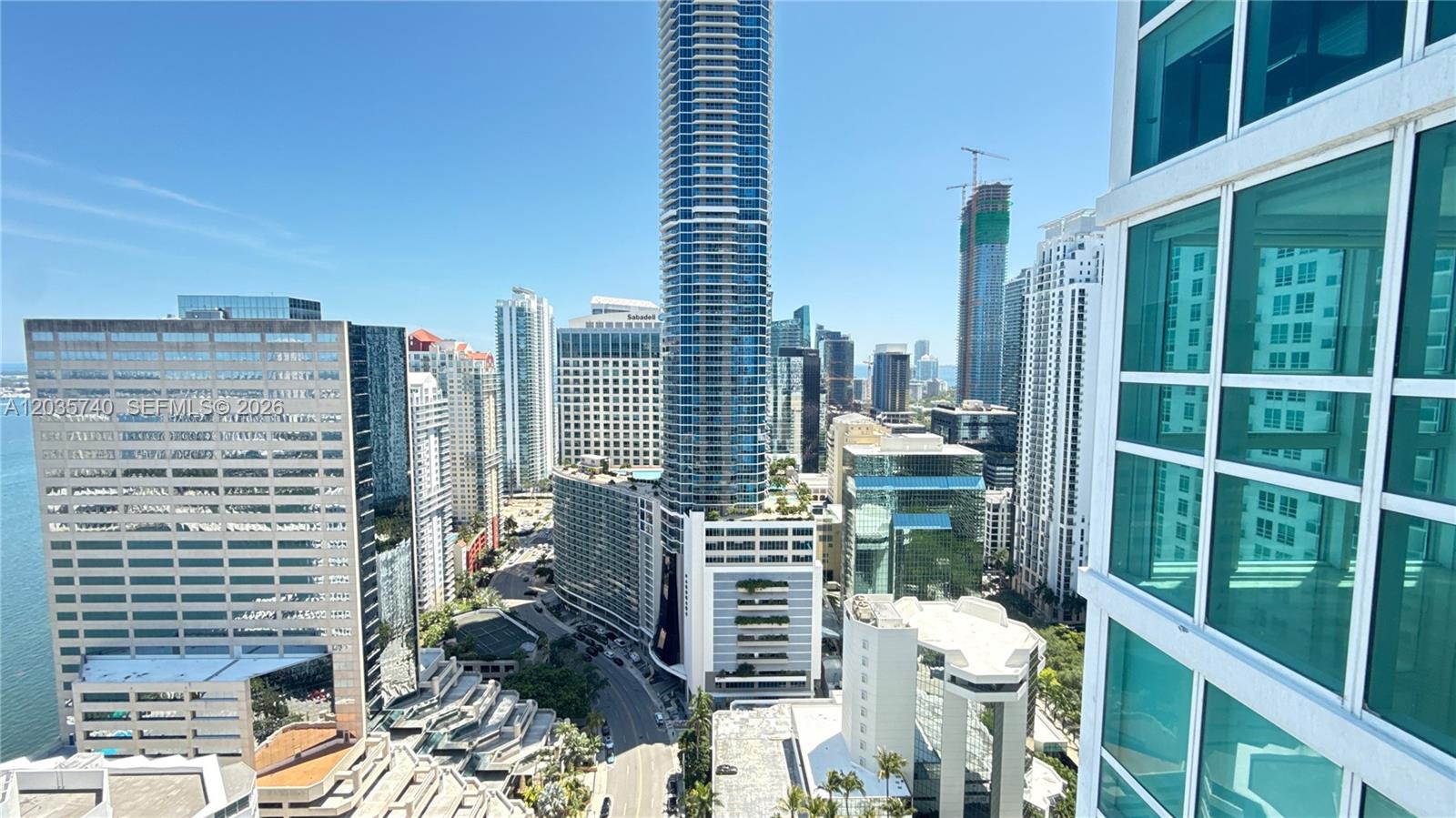 An elevated view of a dense urban skyline featuring numerous skyscrapers and a waterfront — 950 Brickell Bay Dr # 3411, Miami FL 33131, MIAMI, FL