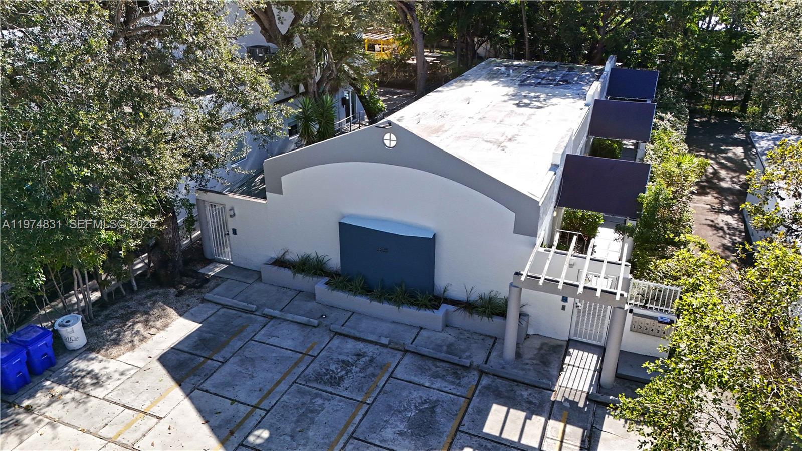 An aerial view shows a single-story building with a flat roof and paved parking area — 2825 SW 3rd Ave, Miami FL 33129, MIAMI, FL