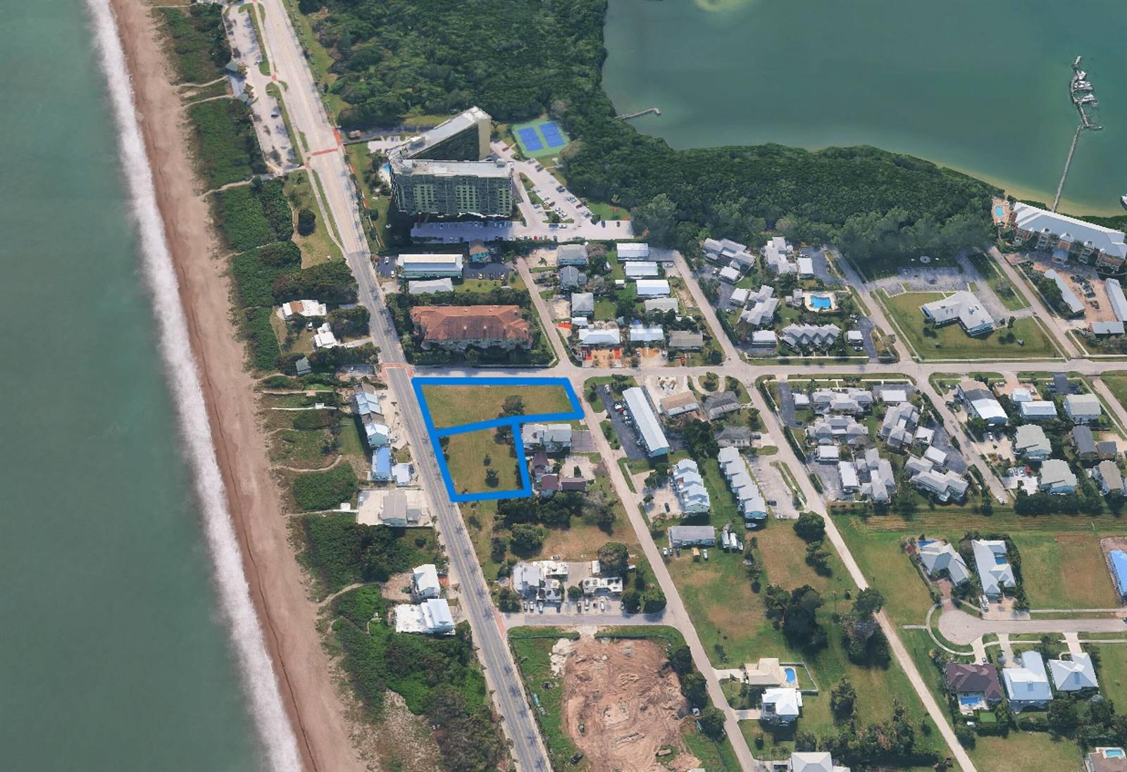 An aerial view shows two adjacent vacant lots outlined in blue near a coastal road — 609 & 615 S Ocean Drive, Fort Pierce FL 34949, FORT PIERCE, FL
