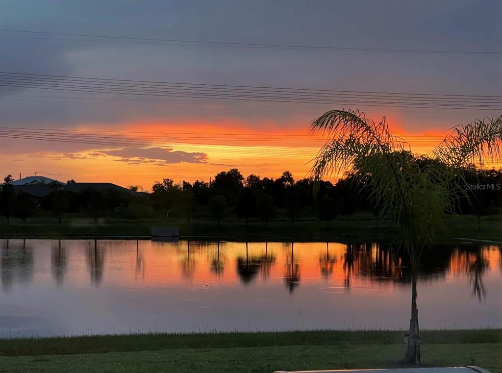 A two-story suburban house with a gray exterior, a two-car garage, and a front porch — 1507 GOLDEN GLOW DRIVE, RUSKIN, FL