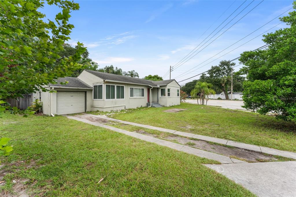 A backyard features a rectangular swimming pool with a white concrete deck and palm trees — 1714 N BUMBY AVENUE, ORLANDO, FL