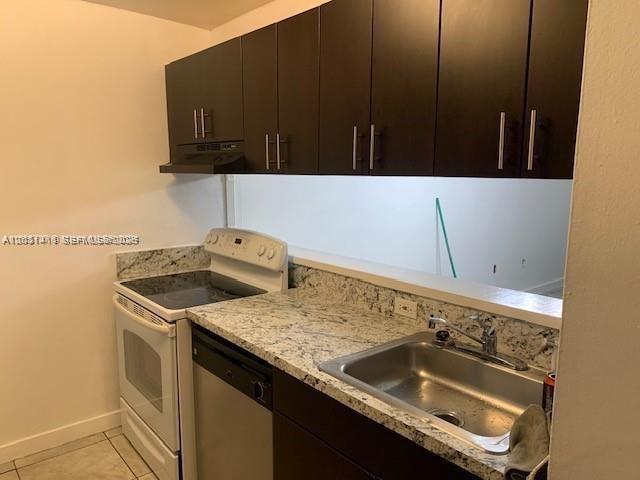 A kitchen features dark wood cabinets, granite countertops, a stainless steel sink, and white appliances — 10801 SW 109th Ct # D203, Miami FL 33176, MIAMI, FL