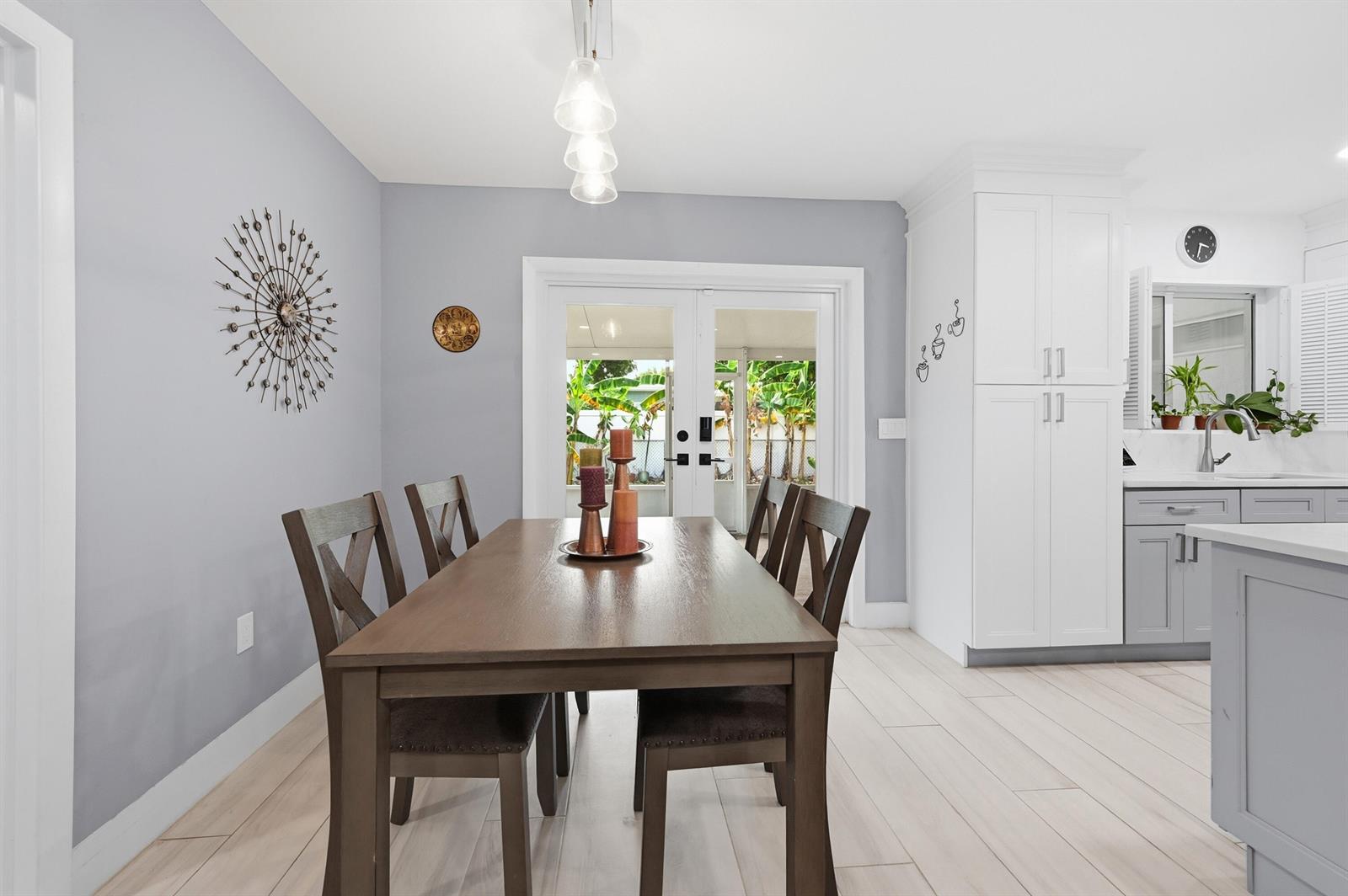 A home bar area features white cabinetry, a marble countertop, glass-front appliances, and open shelving — 141 SE 8th Street, Pompano Beach FL 33060, POMPANO BEACH, FL